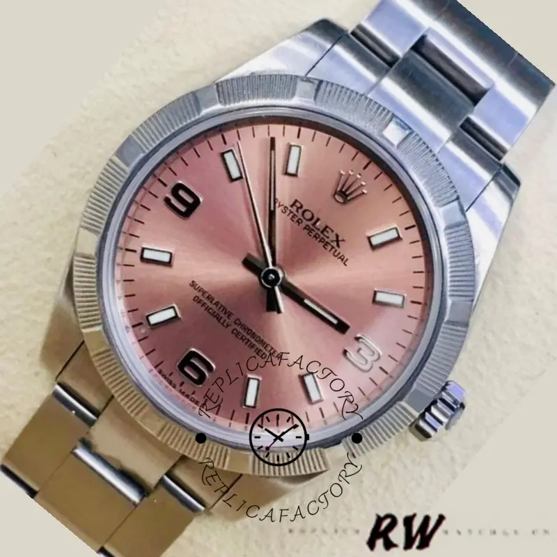 Rolex Oyster Perpetual 177210, angled close-up showing pink dial, hands, and smooth bezel.