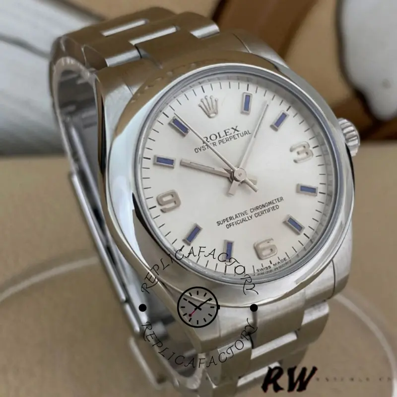 Rolex Oyster Perpetual 177200 angled view, silver dial and blue markers, on cushion.