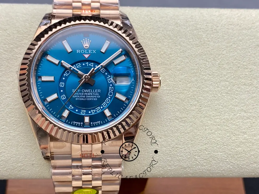 Front view of the Rolex Sky-Dweller m336935 0005 on pillow, blue-green dial and fluted bezel.