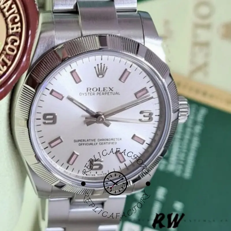 Rolex Oyster Perpetual 177210, dial close-up showing pink markers and Rolex crown logo.