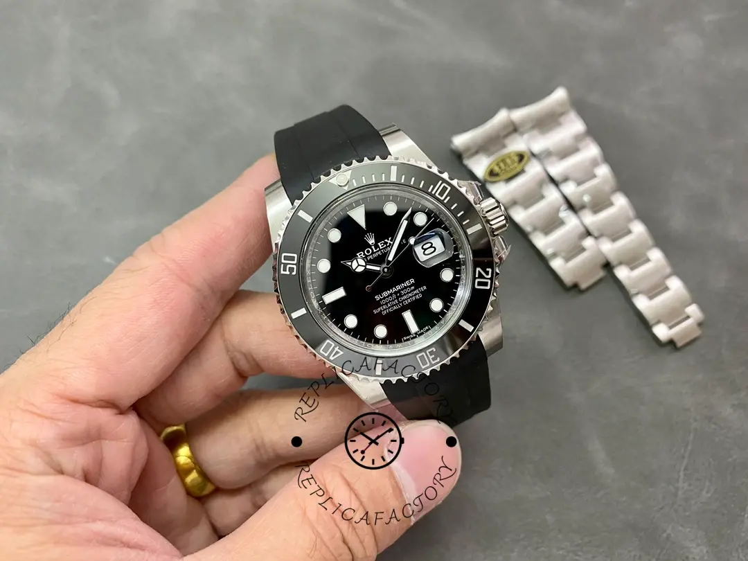 Rolex Submariner 126610LN, held in hand showing full case and black rubber strap.