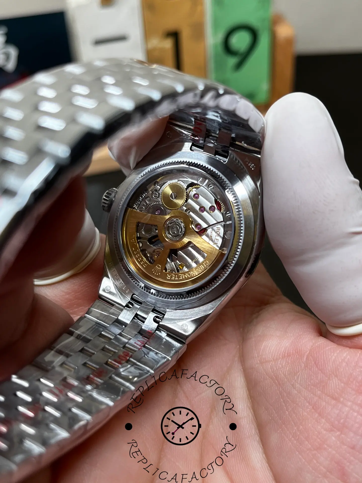 Caseback view of Rolex Land-Dweller 36 m127236-0001 showing the open-back movement and rotor details.