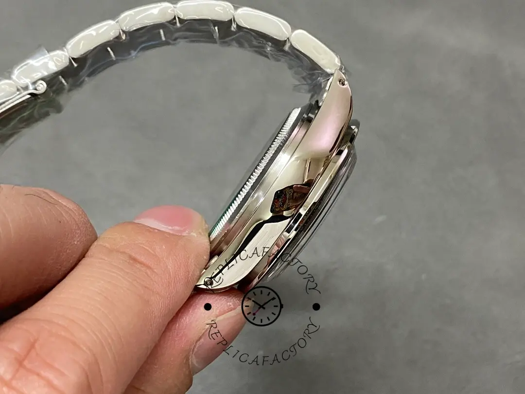 Side profile of Rolex Daytona 6241 in hand, showing case thickness and bezel edge.