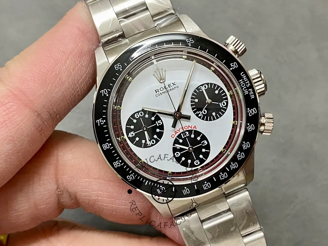 Handheld close-up of Rolex Daytona 6241 highlighting the black bezel and chronograph subdials.