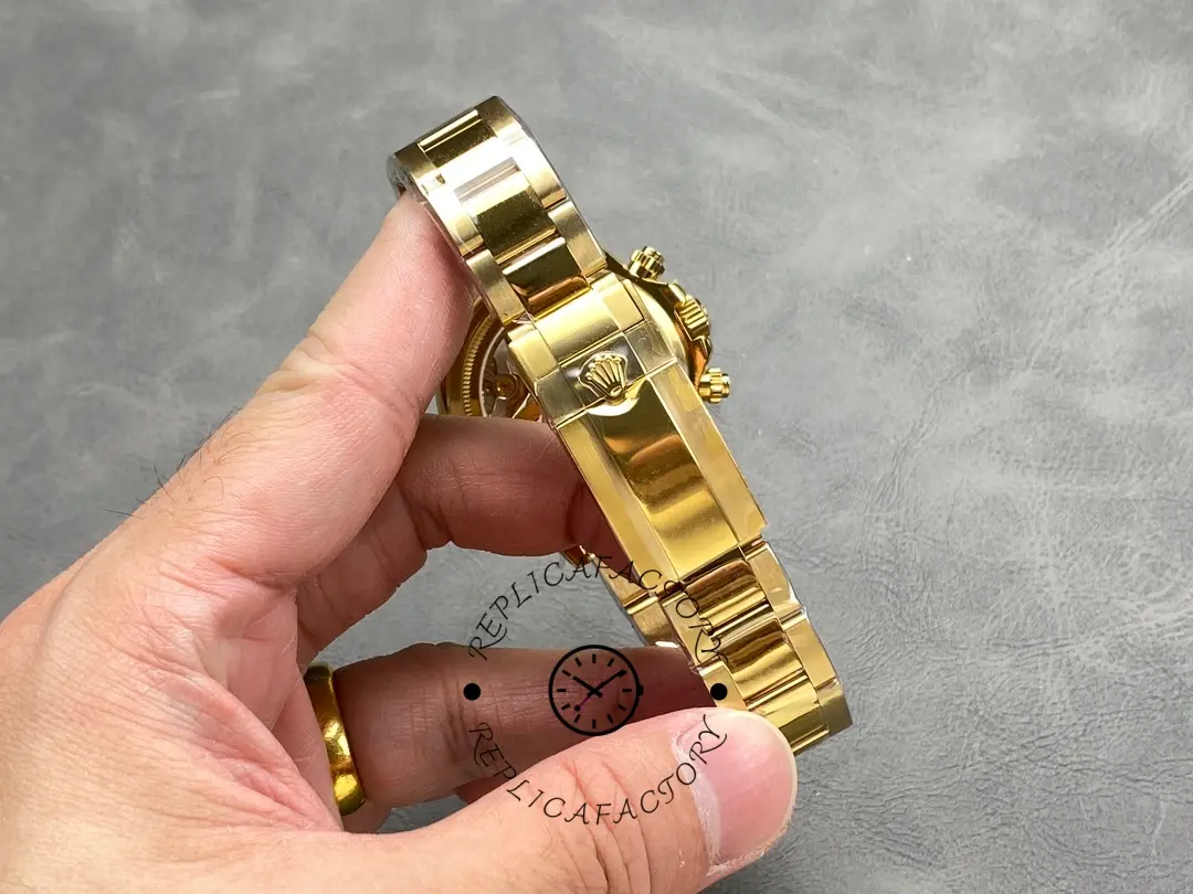 Rolex Daytona 126528LN-0001, bracelet and clasp detail shown in hand.
