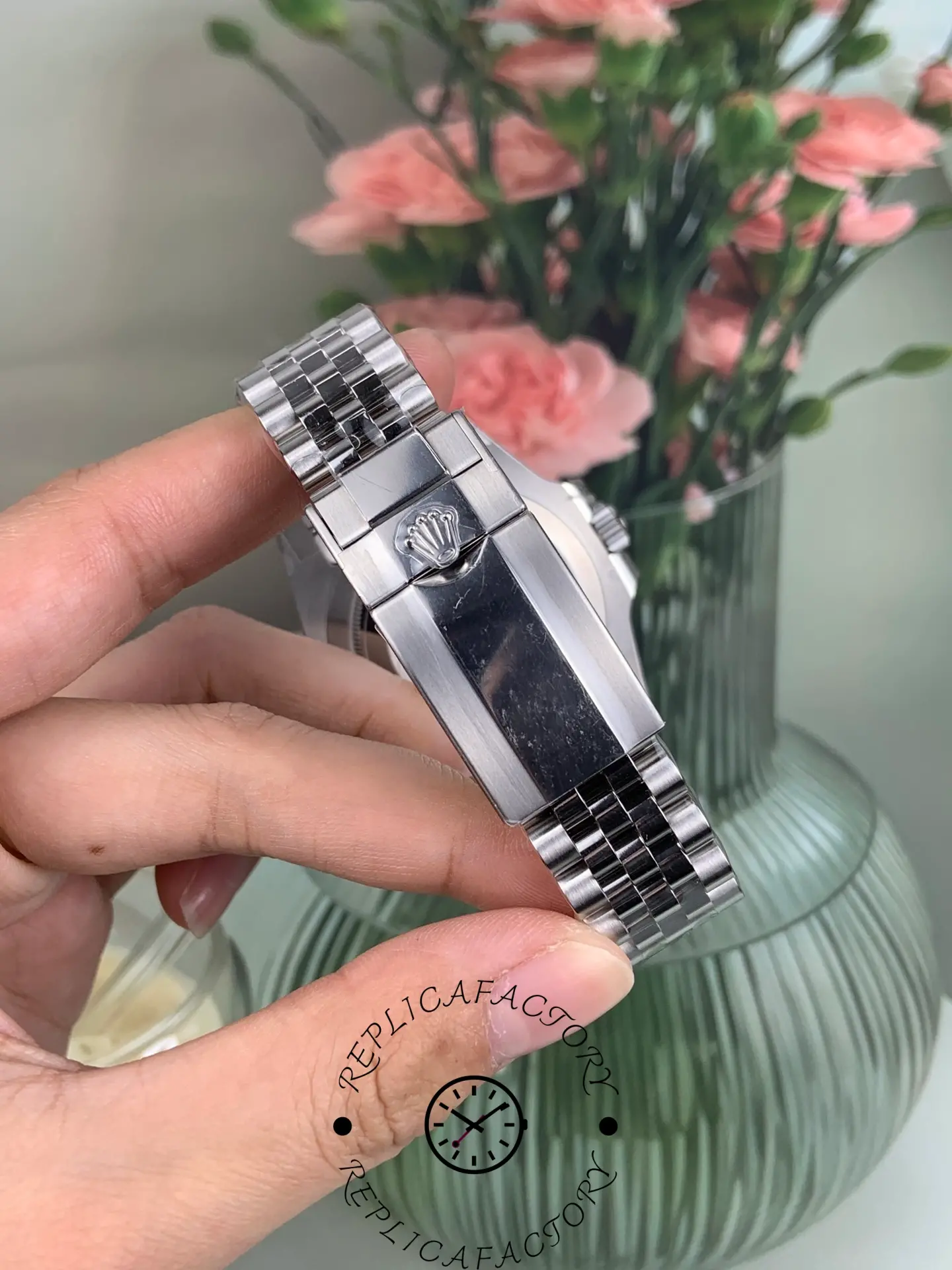 Rolex GMT-Master II 126710BLRO clasp close-up showing Rolex crown logo on polished clasp surface.